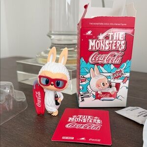 Monsters Coca-Cola Labubu Pop Mart Figure with Red Surfboard and Sunglasses